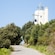 A road surrounded by vegetation and leading up to Gorliz Lighthouse